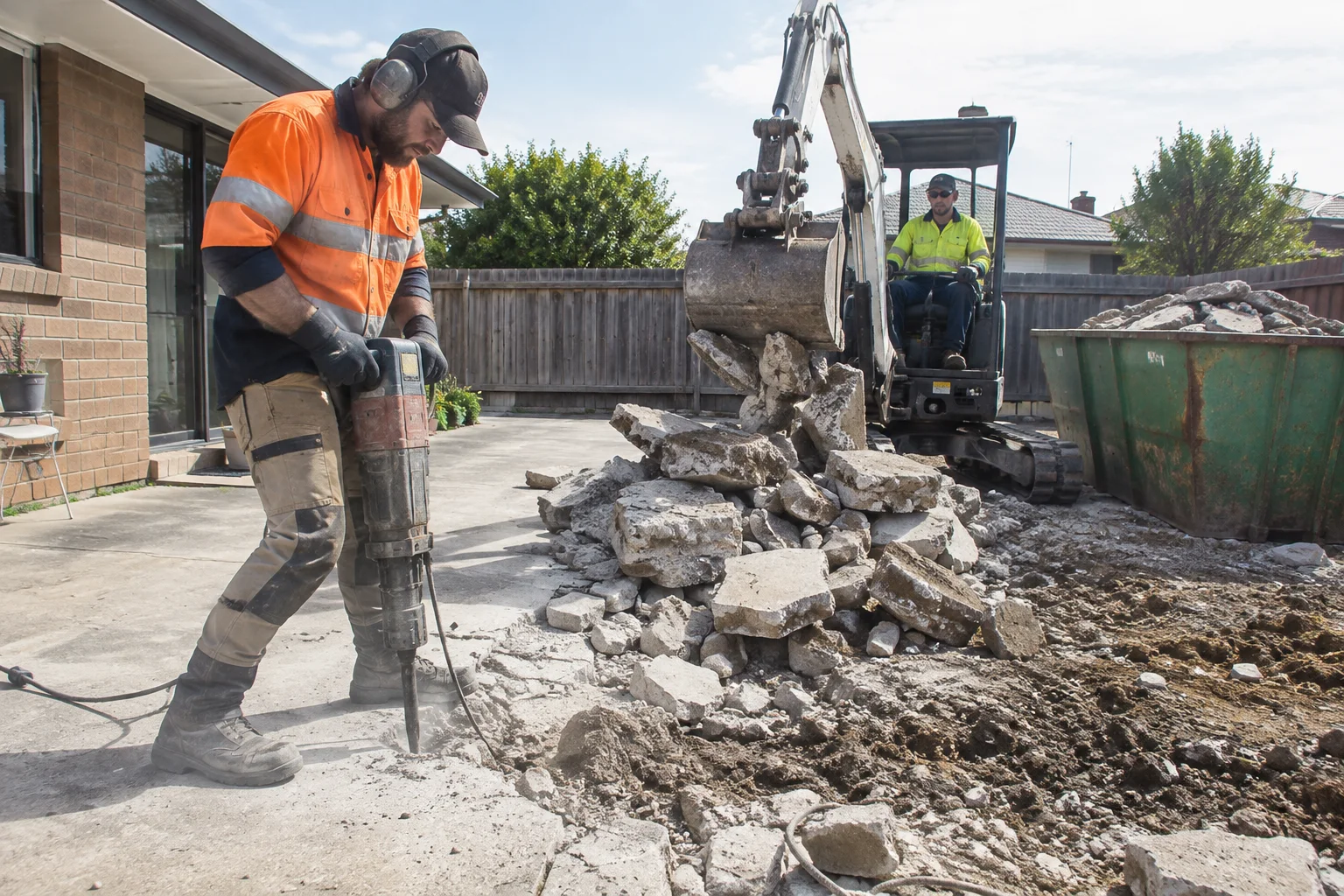 Tradespeople working on concrete recycling in a Geelong-style residential setting