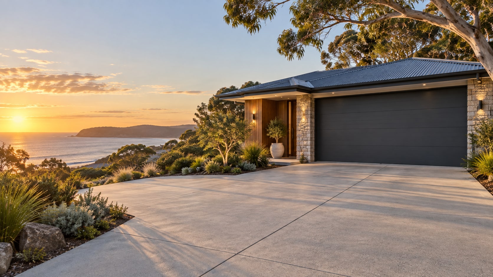 Coastal Geelong home with a concrete driveway, native landscaping and warm evening light